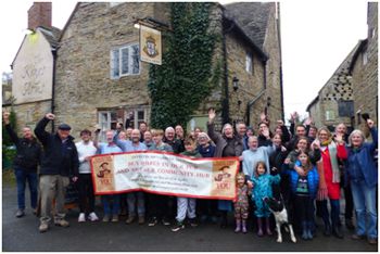 Villagers celebrating outside the pub